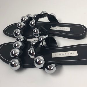 black slides with silver balls